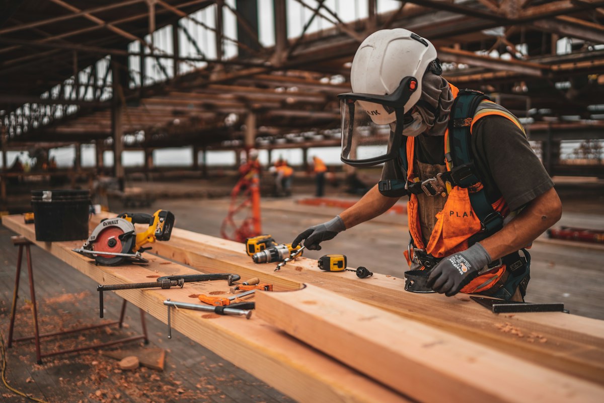 Carpenter checking a layout on a long timber